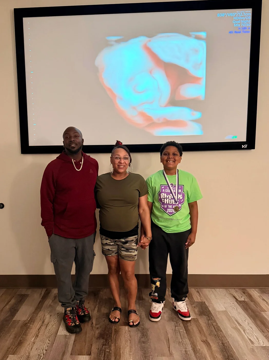 Three guests watching an ultrasound projected on the studio’s large screen